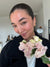 Woman holding a bouquet of flowers indoors