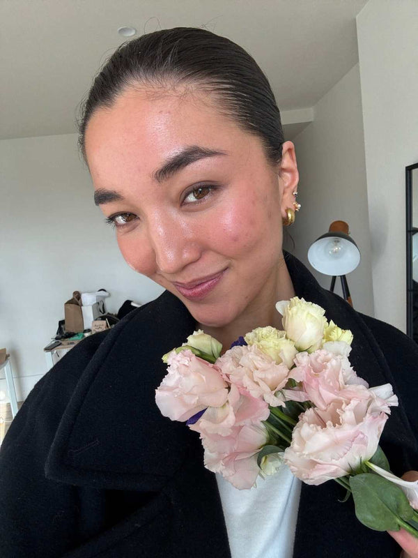 Woman holding a bouquet of flowers indoors